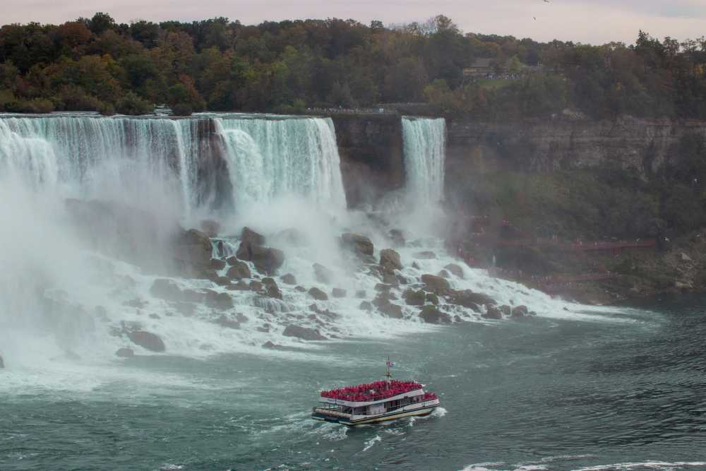 frustrated writer, laptop, blank screen, crumpled paper, travel maps, coffee mug
