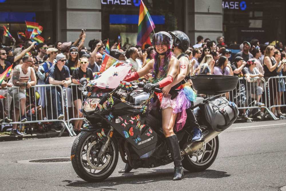 NYC Pride Parade, massive crowd, rainbow flags, 5th Avenue, celebration, confetti, vibrant colors}