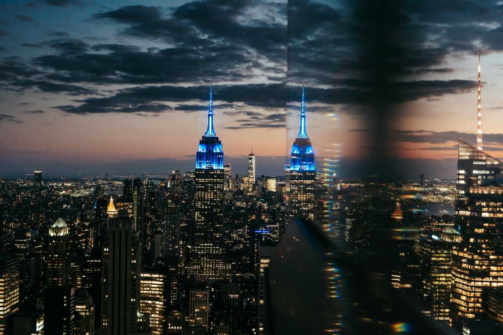 NYC rooftop party, Halloween costumes, Manhattan skyline, night, cocktails, city lights, glamorous}