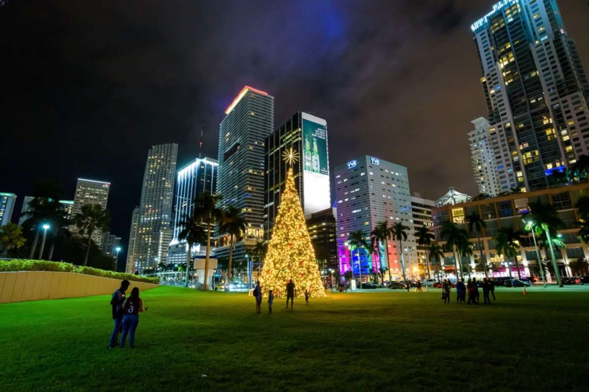 Christmas Wonderland Miami, Tropical Park lights, holiday theme park, family fun, festive rides, light display, children enjoying}