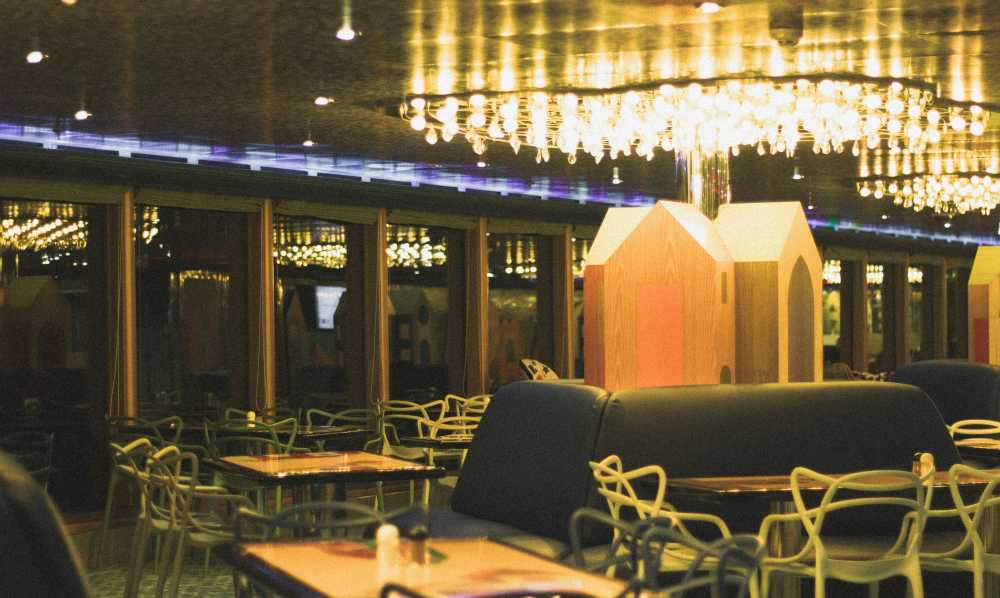 solo female traveler, toasting, glass of wine, city view, sunset, celebration, self-reliance}