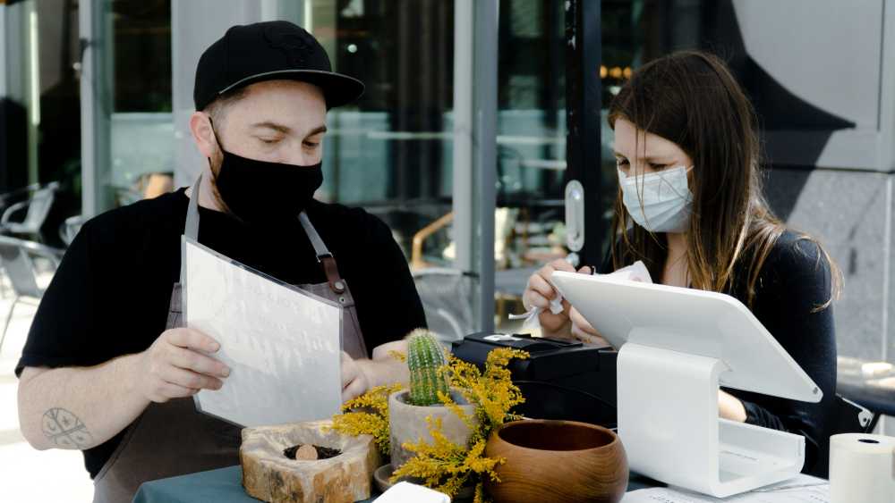 traveler working on laptop, scenic background, digital nomad, secure connection, remote work, peace of mind}