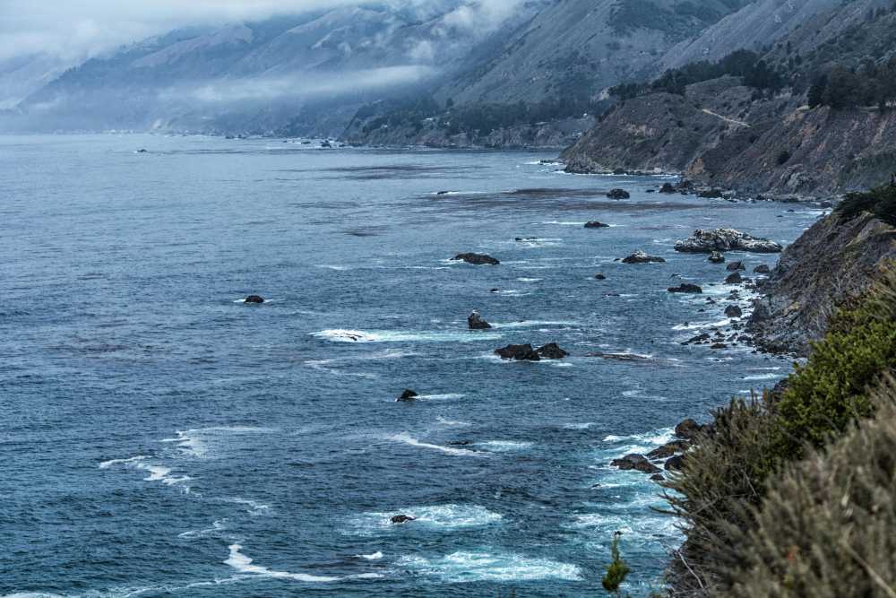 family beach packing flat lay, sunscreen, kids sunglasses, sand toys, beach towels, straw hat, travel preparation