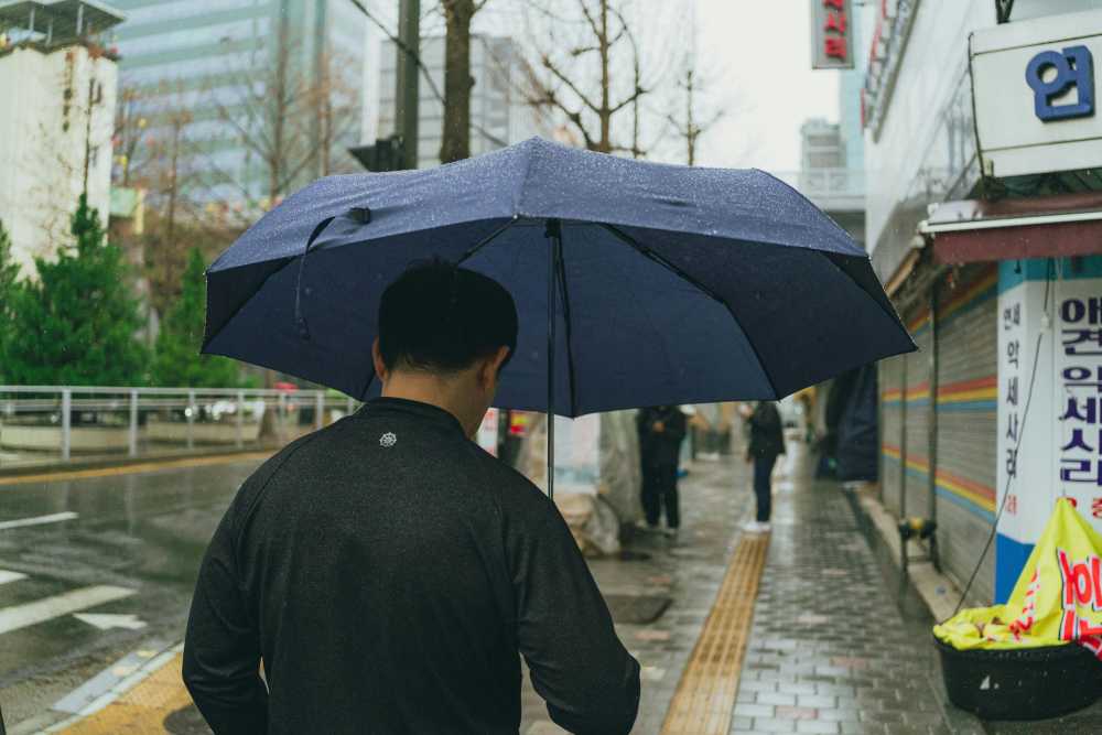 traveler using laptop with VPN, coffee shop, digital security, public wifi, data protection, cybersecurity