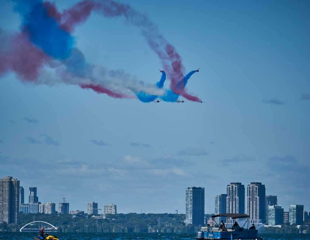 family on beach at night, watching distant fireworks, South Pointe Park, Miami Beach, relaxed atmosphere, picnic blanket, ocean view}