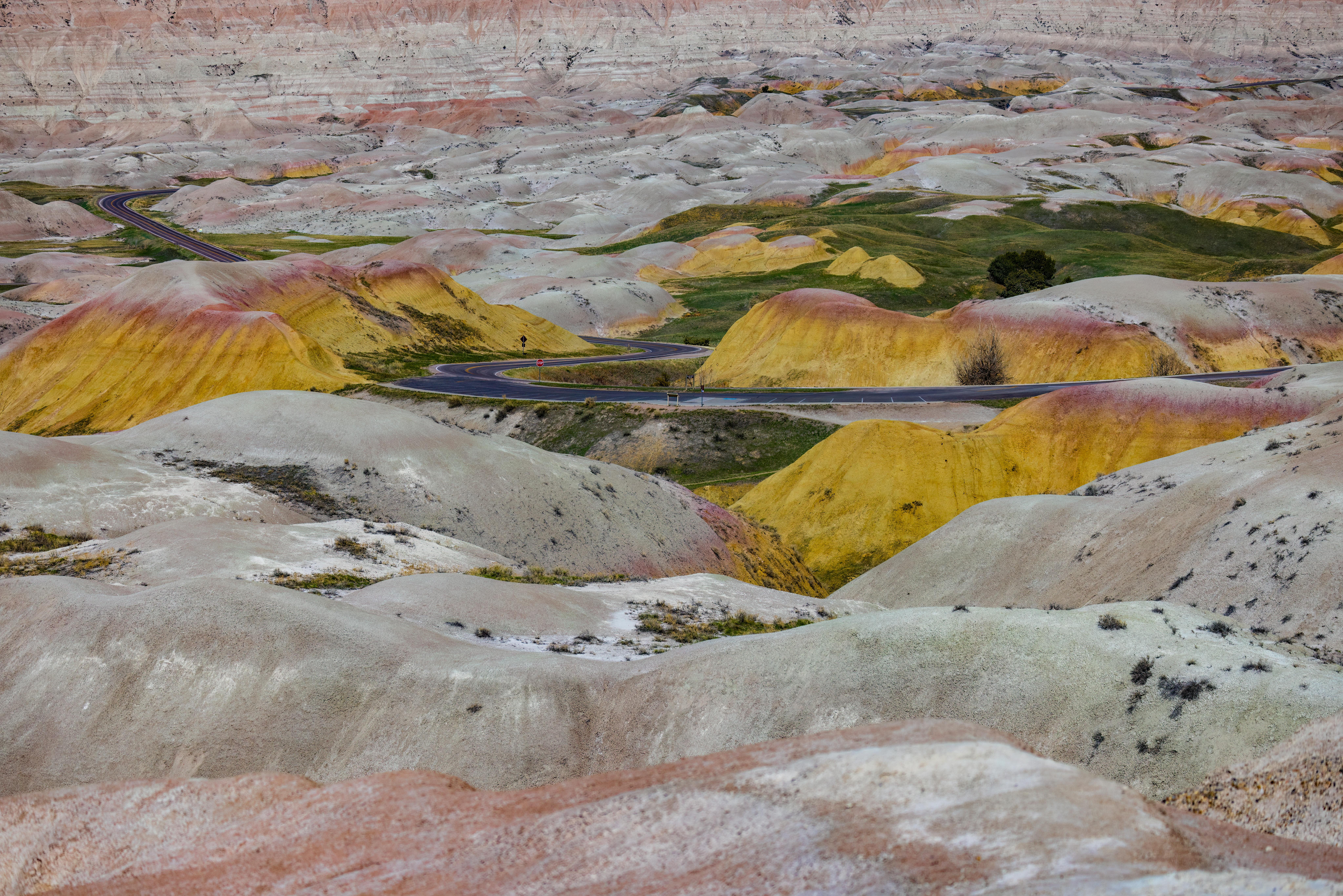 Badlands National Park, sunset, rock formations, dramatic sky, South Dakota, scenic drive, colorful landscape