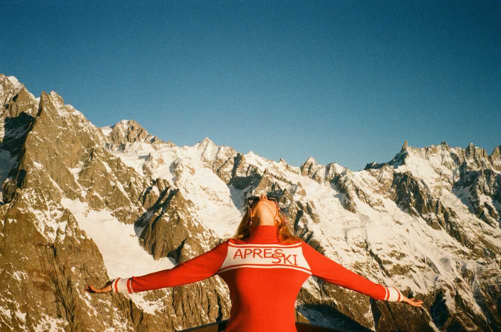 woman on mountain summit, arms raised, success, freedom, solo adventure, achievement}