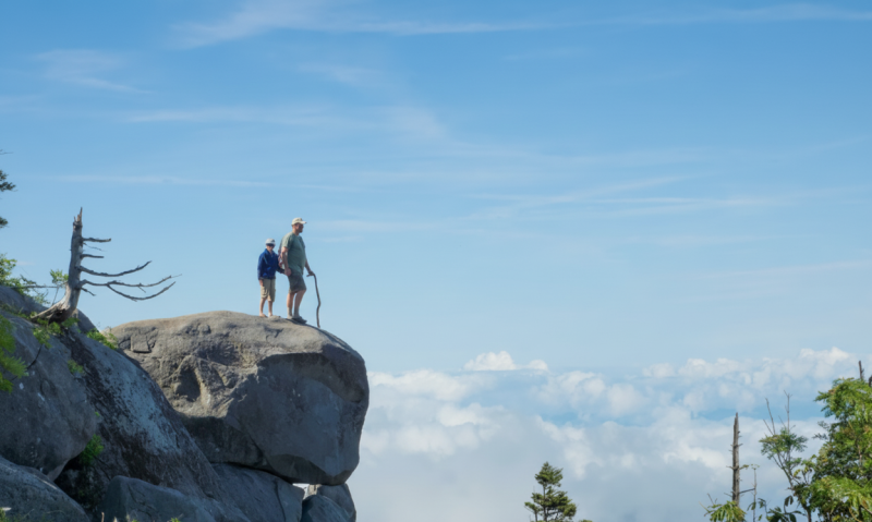 multigenerational family portrait, grandparents, grandchildren, smiling, happy, vacation home porch, candid moment, together