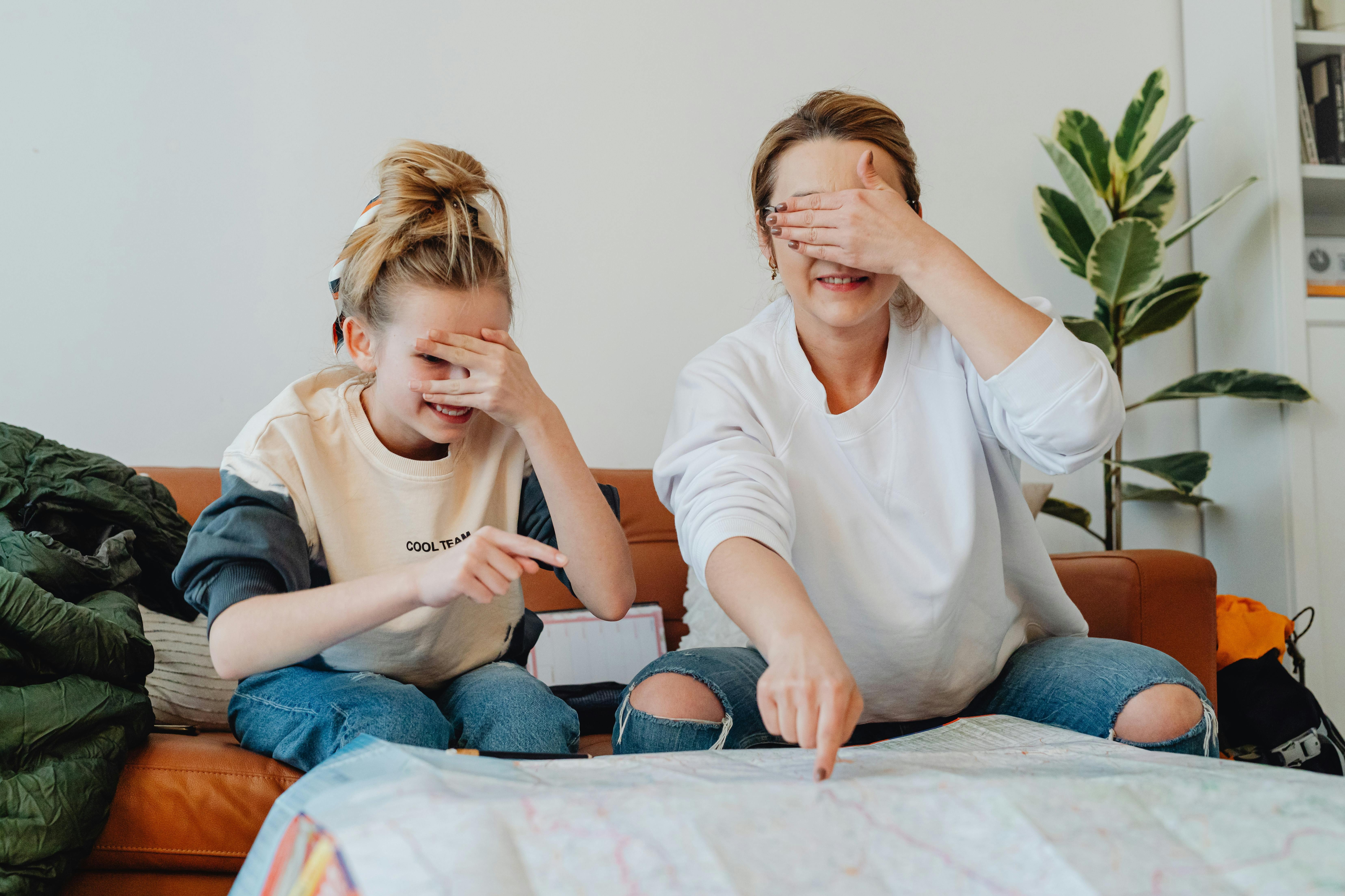family looking at world map, planning adventure, kids pointing at globe, travel inspiration at home, wanderlust, family together