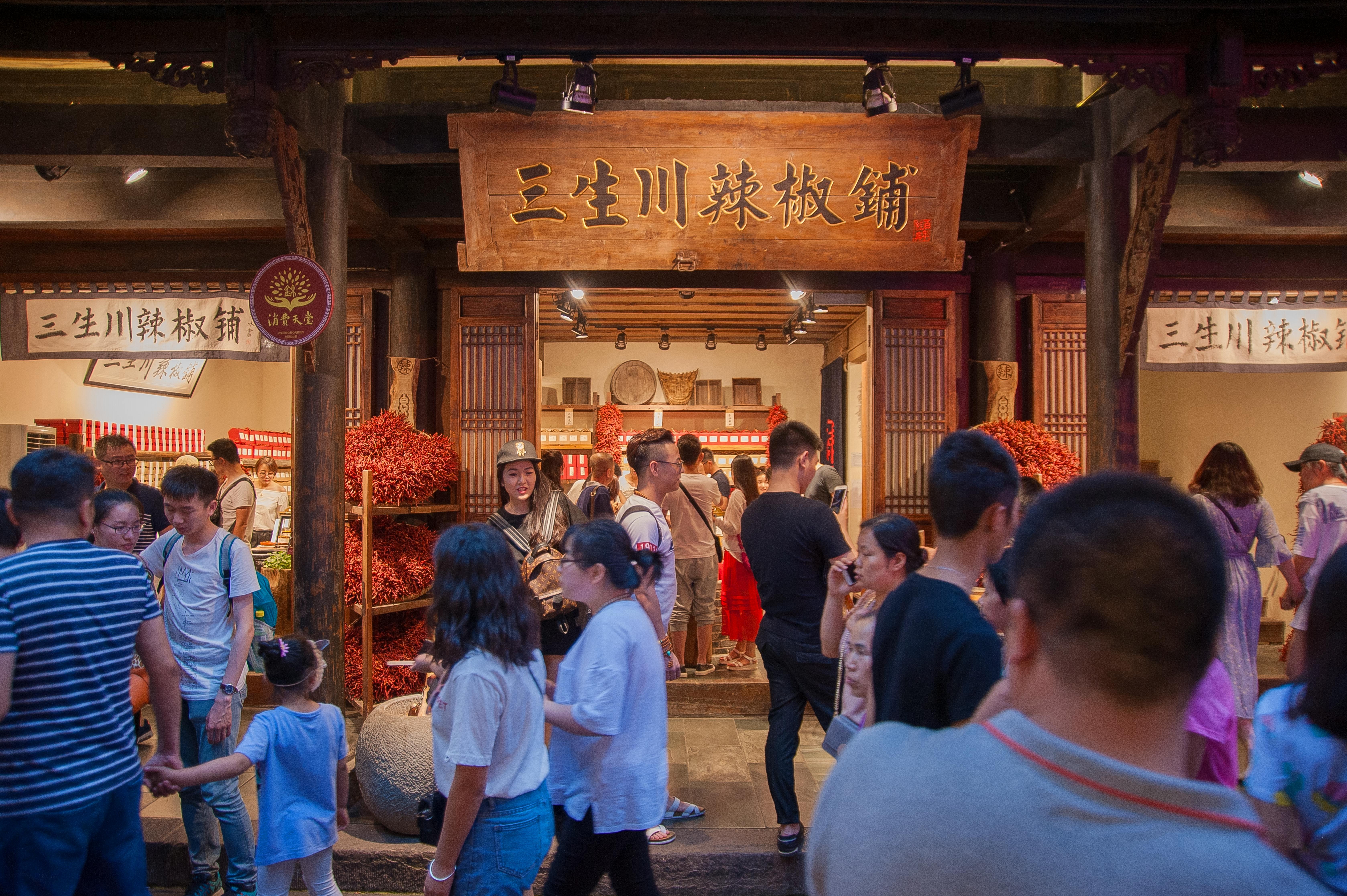 traveler eating street food, Vietnam, smiling local vendor, authentic interaction, candid shot, travel photography