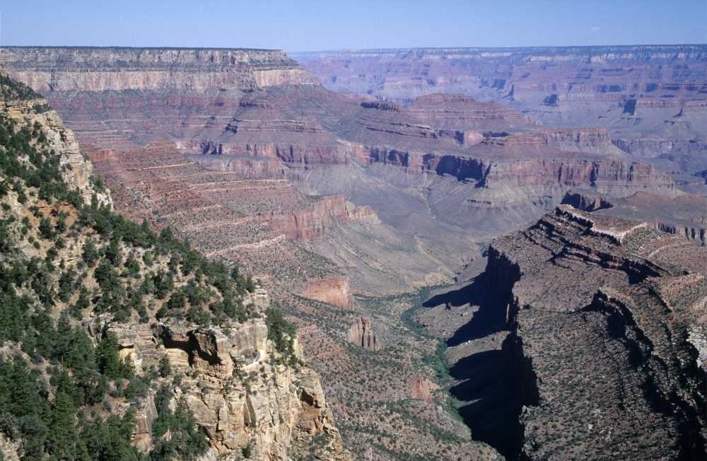 woman with backpack, mountain summit, arms raised, success, freedom, solo adventure, achievement}